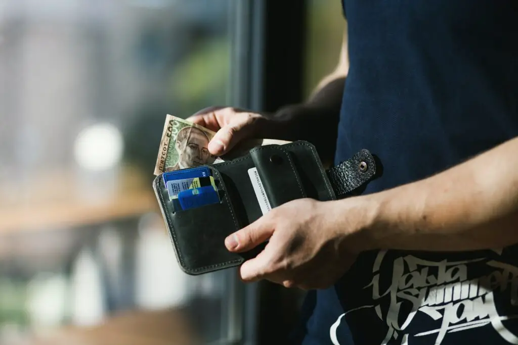 Photograph of Person Holding Black Leather Wallet with Money dream