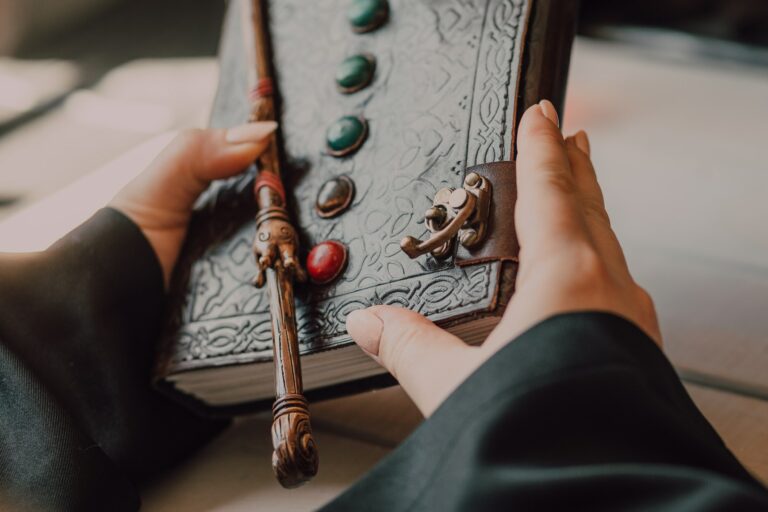 Hands with Medieval Leather Book and Wand chakra